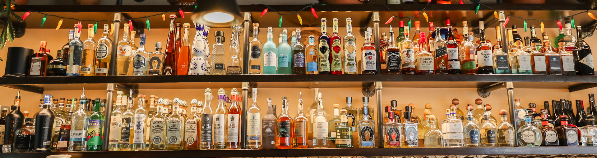 The tequila and mezcal wall at Sergio's Cantina, stocked with 70+ bottles